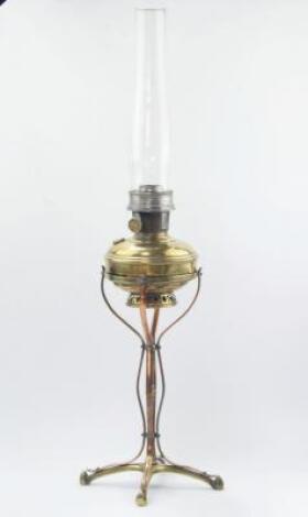 An Art Nouveau brass and copper paraffin lamp