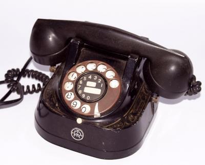 An early 20thC bell ebonised metal and gilt stencilled telephone