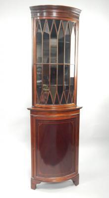 A Victorian mahogany bowfronted corner display cabinet