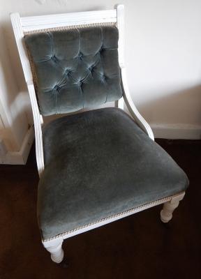 A white painted Victorian low seated nursing chair