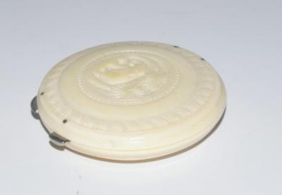 A 1930's carved ivory powder compact.