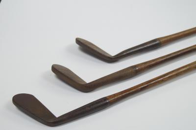 Three mid 20thC iron blade golf clubs