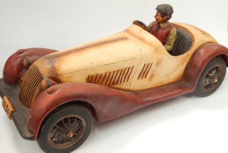 A wooden model of a 1930's Morgan style car