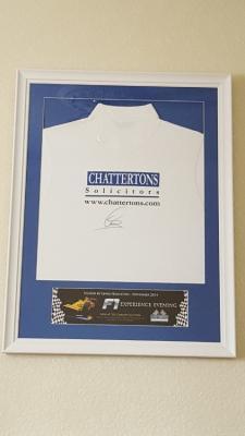 A framed polo shirt signed by reigning F1 world champion