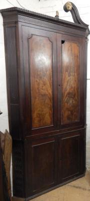 A George III mahogany standing corner cabinet