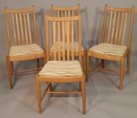 A set of four modern Ercol light elm dining chairs