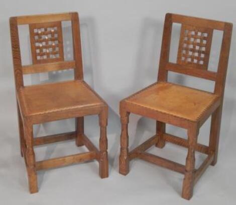 A pair of oak dining chairs by Robert Mouseman Thompson