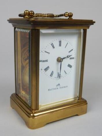 A modern brass and bevelled glass carriage timepiece by Matthew Norman