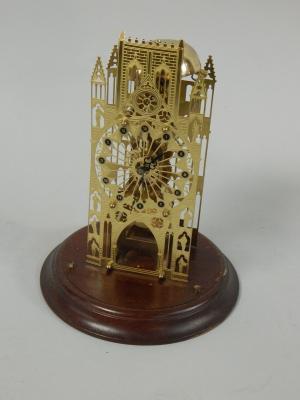 A modern engraved brass skeleton type clock