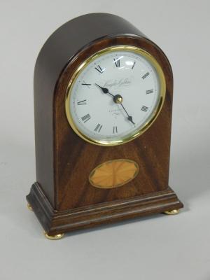 A modern mahogany and marquetry mantel clock