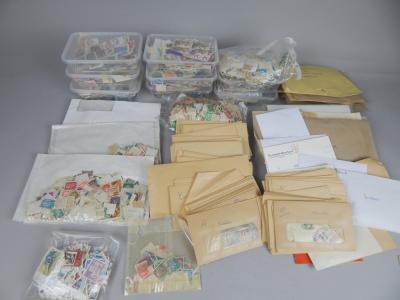 A large quantity of cut postally used mixed world stamps