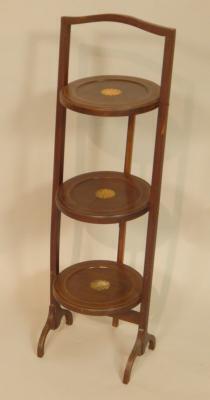 An Edwardian mahogany three tier cake stand