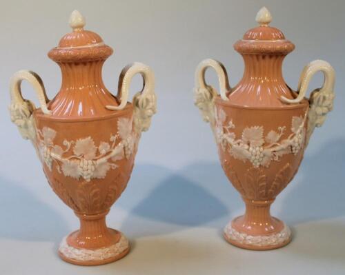 A pair of late 19thC peach and milk glass urns