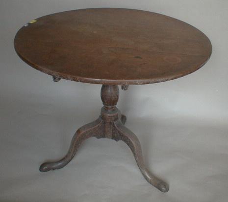 A George III oak supper table with circular top