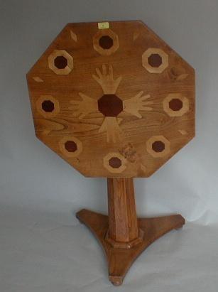 A 19thC elm pedestal table with octagonal tilt top inlaid with similar