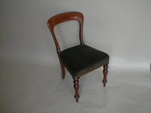 A pair of Victorian mahogany hoop back chairs with green velvet overstuffed