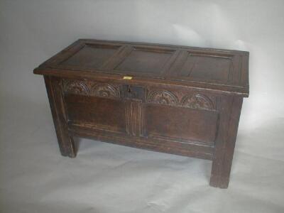 A 17thC oak coffer with three panel top