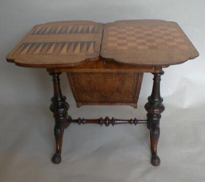 A Victorian burr walnut work and games table with moulded and shaped swivel