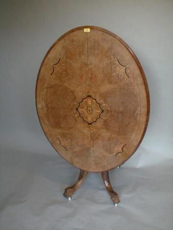 A Victorian walnut marquetry loo table with oval moulded and inlaid tilt