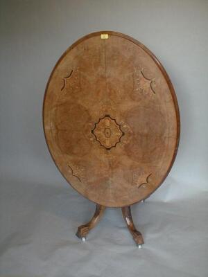 A Victorian walnut marquetry loo table with oval moulded and inlaid tilt