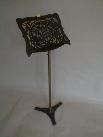 A Victorian music stand with rosewood fretwork panel supported by a brass