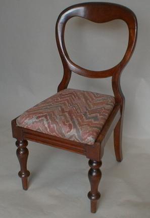 A pair of Victorian mahogany balloon back dining chairs with drop-in seats