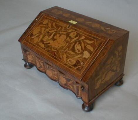 A Dutch style walnut floral marquetry miniature bureau with fall flap revealing