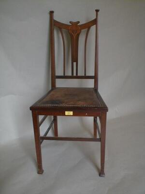 An Art Nouveau mahogany boudoir chair inlaid with stylized tulips