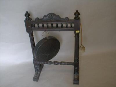 A Late Victorian oak dinner gong with carved and turned framing with reeded