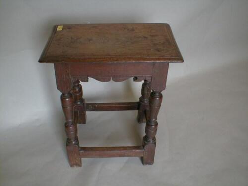 A 17thC oak joint stool with moulded top