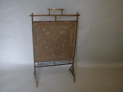 A Victorian bamboo framed firescreen with a printed linen panel