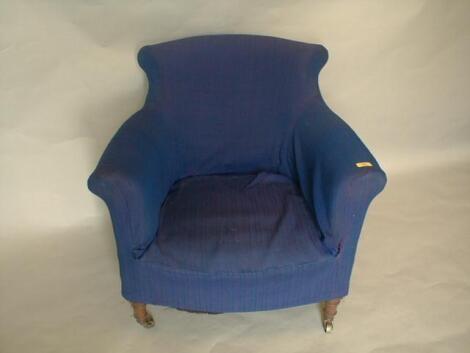 A Victorian upholstered armchair with scrolling back and arms