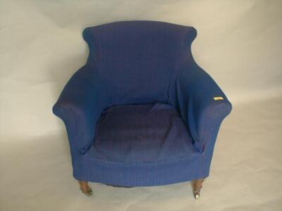 A Victorian upholstered armchair with scrolling back and arms