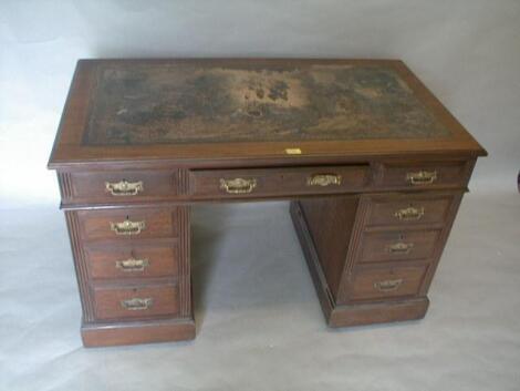 A late Victorian walnut kneehole desk with three frieze drawers and three