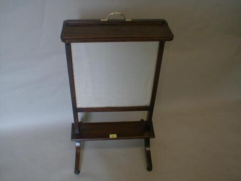 A Victorian rosewood adjustable firescreen with rise and fall panel on sabre legs