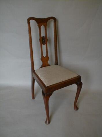 A set of 4 Edwardian walnut dining chairs with pierced high backs