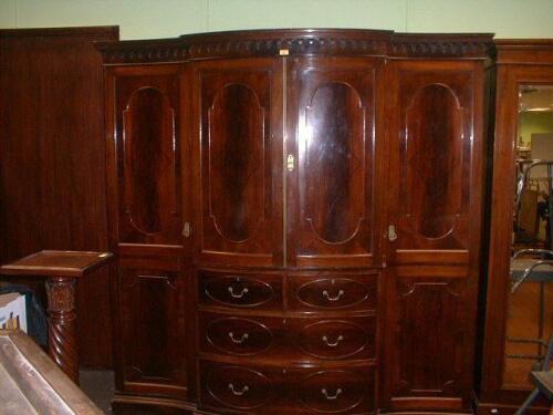 A Georgian style flamed mahogany wardrobe compactum by Howard & Sons Ltd.