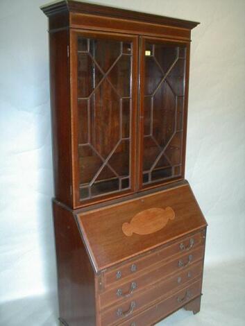 An Edwardian mahogany bureau bookcase with satinwood cross banding and