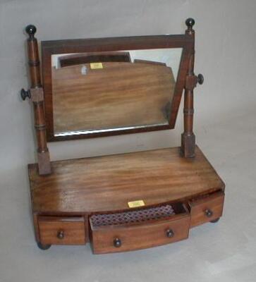 An early 19thC mahogany bow front dressing table mirror with rectangular plate