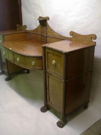 A Regency mahogany twin pedestal sideboard with shaped splash back