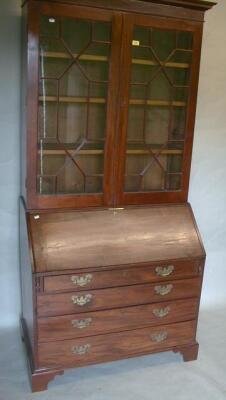 A George III and later mahogany bureau bookcase with moulded cornice over