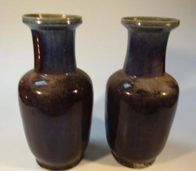 A pair of blue glazed vases