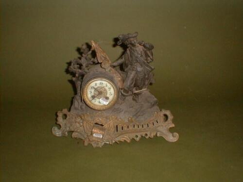 A 19thC French spelter figural mantel clock surmounted with a cavalier on a rococo base