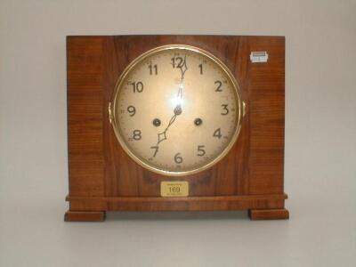 An Art Deco cross banded walnut mantel clock with Arabic numerals