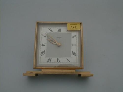 A Bentima gilt brass table clock with step base