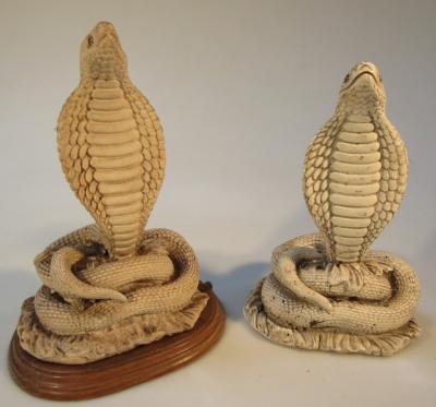 A near matching pair of Indian polished figures of cobras