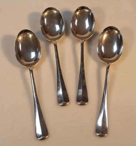 A set of four Elizabeth II silver rattail serving spoons