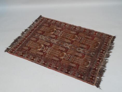 A hand woven Middle Eastern hearth rug