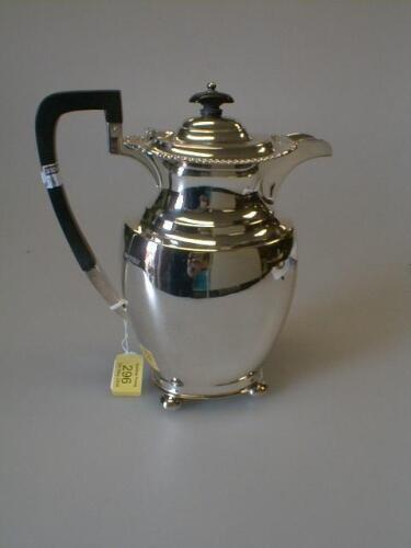 A silver hot water jug