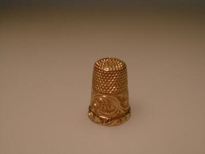 A yellow metal thimble